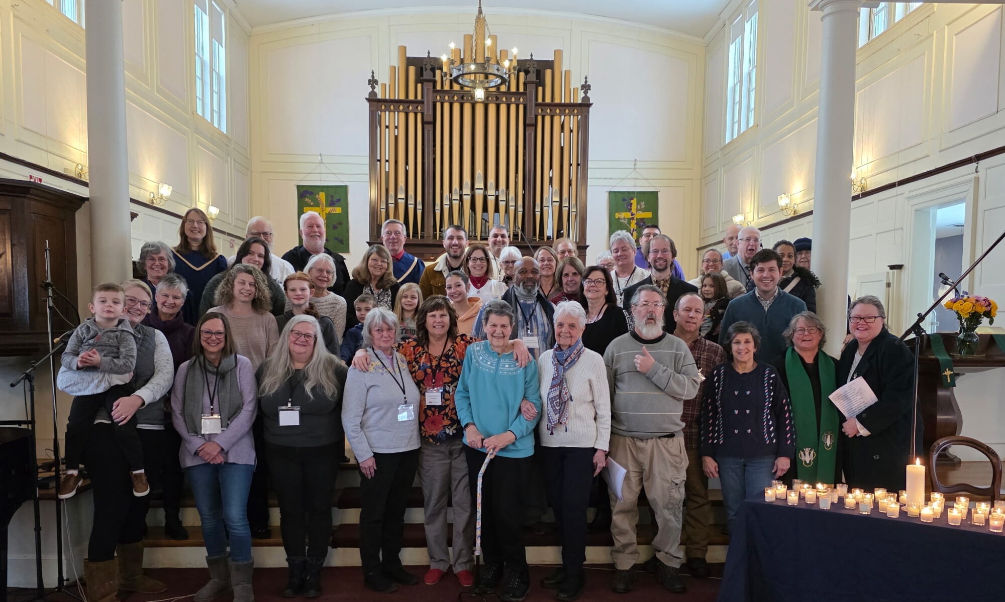 Group of congregants standing at front of sanctuary.